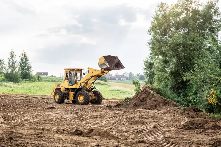 large yellow wheel loader aligns a piece of land for a new building | Land Clearing by Sorko Services in Central Florida